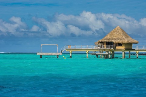 Overwater bungalows on stilts in luxury hotel