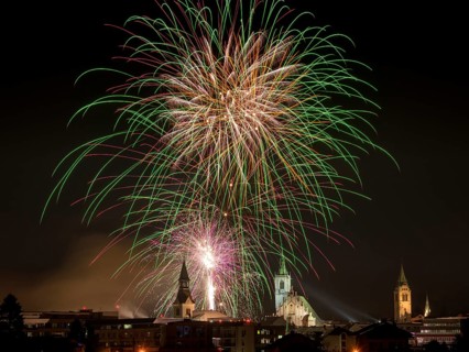 Fireworks over Schwaz on New Year's Eve with hospital church and parish church