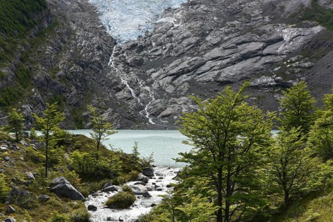 Melting glacier with lake and forest