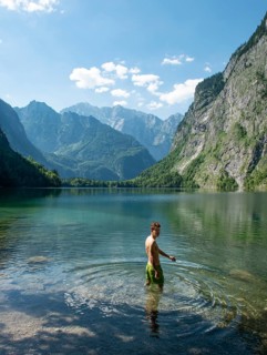 Young man bathes in lake Obersee