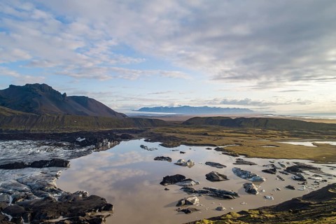 Calving glacier with volcanic massif