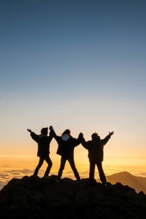 Tourists in backlight waiting for sunset on top of Haleakala National Park