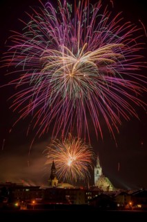 Fireworks over Schwaz on New Year's Eve with hospital church and parish church