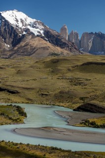 Snow covered peaks of the granite mountains Torres del Paine with the Rio Paine glacial river