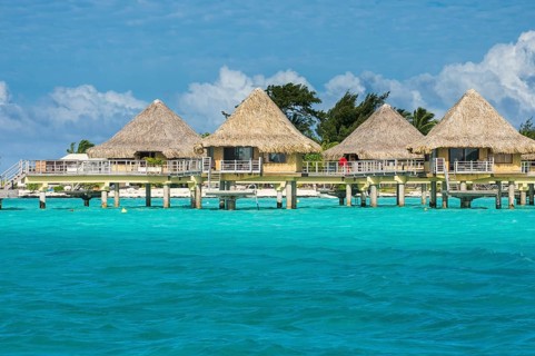 Overwater bungalows on stilts in luxury hotel