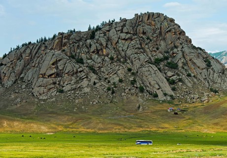 Bus passes a hill of granite in Terelj-Valley