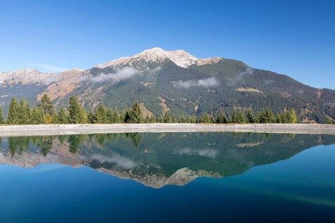 Water reservoir for snow production for the ski slopes on Grubigstein with view to Daniel