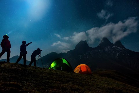 Three photographers backpacking in front of the Les Aiguilles d'Arves mountain