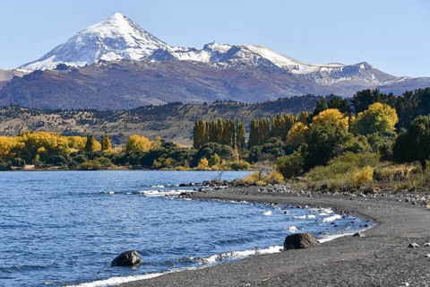 Lake Lago Lolog in autumn with the snow-covered volcano Lanin