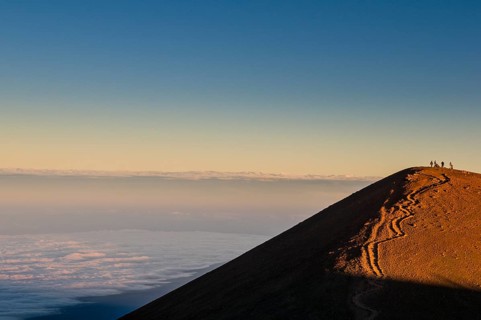 Tourists on a volcanic cone on top of Mauna Kea