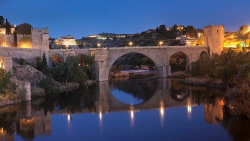 Puente de San Martin bridge reflected in the Tajo River