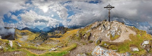 360 mountain panorama from Hochiss summit with summit cross and bizarre cloudy sky
