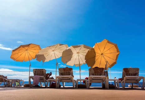 Parasols and sun loungers on a patio