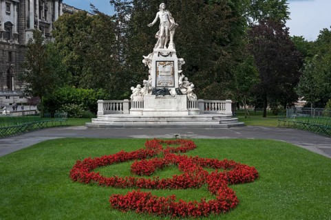 Red flowers arranged as violin key with Mozart monument