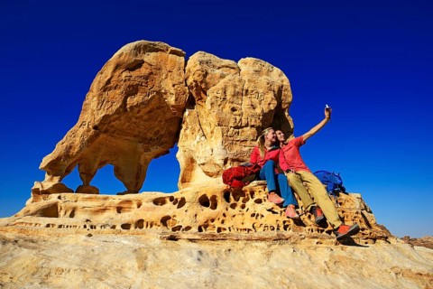 Hikers climb Elephant Rock outside of Petra