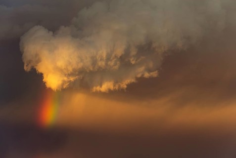 Evening thunderstorm with Cumulonimbus cloud and rainbow above a sand dune