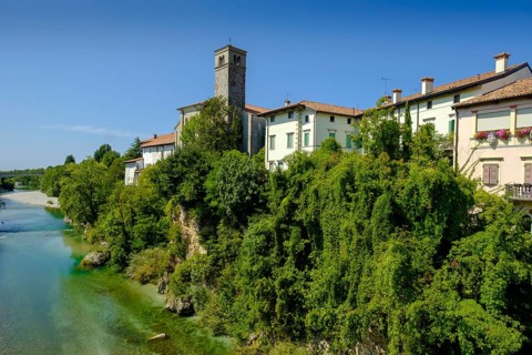 View over the river Natisone to the Campanile of the cathedral Santa Maria Assunta and the old town