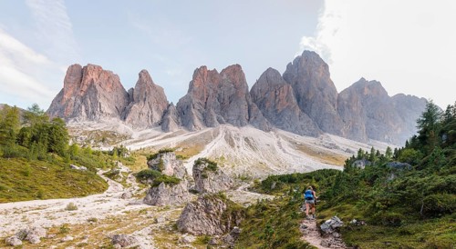 Hiking on footpath to the Geisleralm in the Villnos valley below the Geisler Peaks