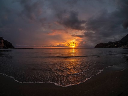 Sunset behind clouds over the sea