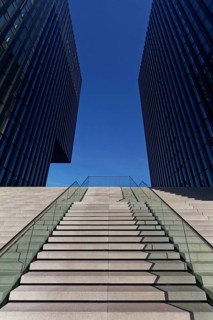 Wide staircase leading upwards between skyscrapers