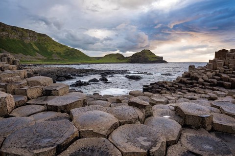 Basalt columns by the coast at sunset