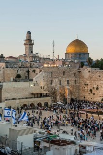 Believers at the Wailing Wall at dusk