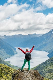 Female hiker is looking at the South Fiord of Lake Te Anau