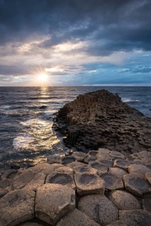 Basalt columns by the coast at sunset