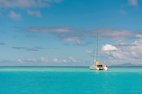 Catamaran in turquoise lagoon