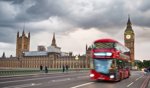Red double-decker bus on the Westminster Bridge