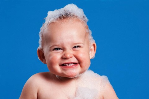 One year-old girl with bath foam on her head