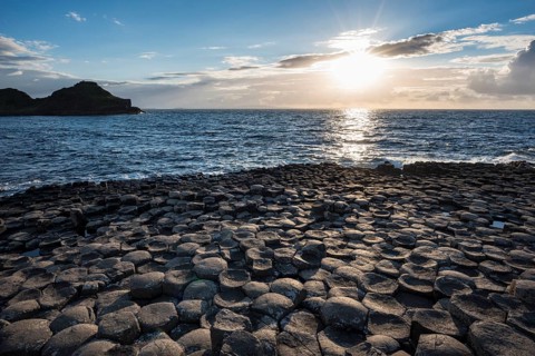 Basalt columns by the coast at sunset