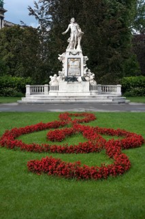 Red flowers arranged as violin key with Mozart monument