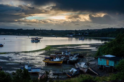Fishing boats at low tide and sunset in Dalcahue