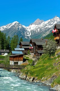 Listed townscape with Swiss chalet houses in front of Valais Alps