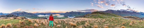 Hiker overlooking Lake Wanaka and mountains