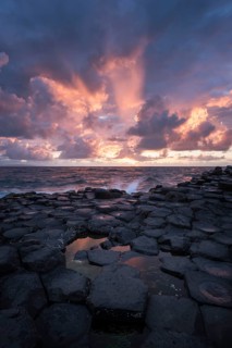 Basalt columns by the coast at sunset