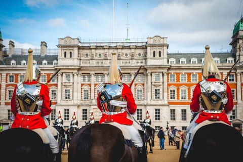 The Royal Guards in red uniform on horses