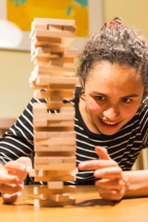 Young woman plays Jenga