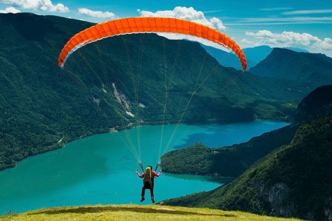 Paraglider starting above Molveno Lake