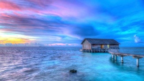 Wooden hut on stilts in lagoon