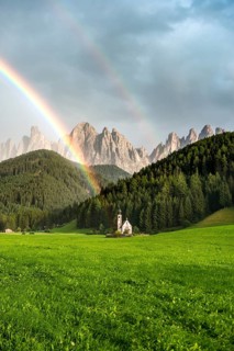 Rainbow in front of the church St. Johann in Ranui