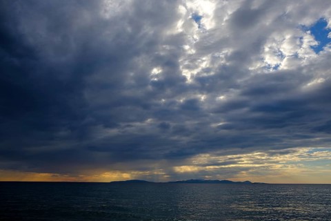 Thunderclouds at sunset on the beach