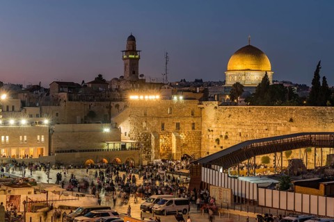 Believers at the Wailing Wall at dusk