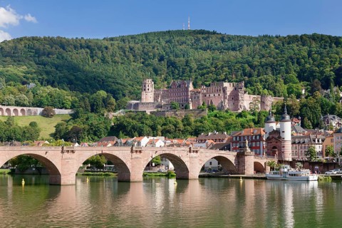 View of Karl Theodor Bridge and Gate over the Neckar River with castle in Heidelberg