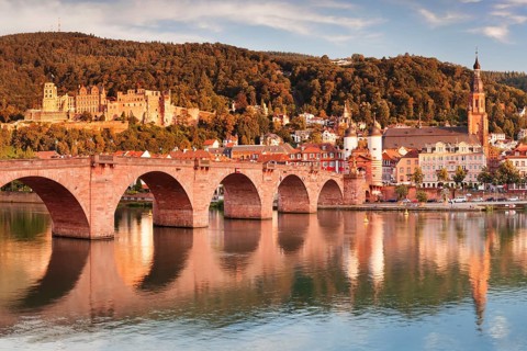 View of Karl Theodor Bridge and Gate over the Neckar River with castle in Heidelberg