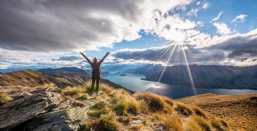 Hiker stretching arms in the air