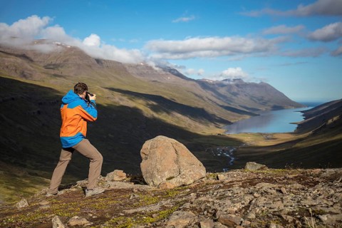 Photographer photographs view from Mjoafjaroarheioi Pass onto Mjoifjorour Fjord