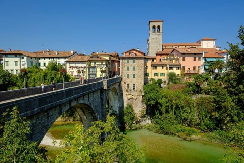 View over the river Natisone to the Campanile of the cathedral Santa Maria Assunta and the old town