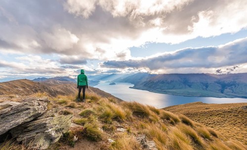Female hiker woman looking at lake